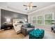 Serene main bedroom with tray ceiling, sitting area, and ample natural light at 626 Oakbourne Way, Woodstock, GA 30188