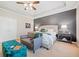 Comfortable main bedroom featuring a sitting area, tray ceiling, and elegant decor at 626 Oakbourne Way, Woodstock, GA 30188