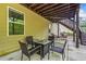 Covered patio area with outdoor seating and a view of the backyard at 626 Oakbourne Way, Woodstock, GA 30188