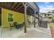 Spacious covered patio with outdoor seating and stairs leading to the backyard at 626 Oakbourne Way, Woodstock, GA 30188