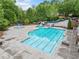 Large community pool with multiple water features and mature trees at 626 Oakbourne Way, Woodstock, GA 30188