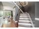 Staircase with hardwood steps, a dark accent wall, and wrought iron spindles at 626 Oakbourne Way, Woodstock, GA 30188