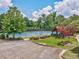 A well-maintained community tennis court is surrounded by lush landscaping, trees, and shade at 626 Oakbourne Way, Woodstock, GA 30188