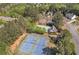An aerial view of tennis courts and pool surrounded by lush greenery, offering community amenities at 1812 Mountain Lake Nw Dr, Kennesaw, GA 30152