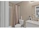 Cozy bathroom with a tub, shower with curtain, toilet, and marble sink at 1812 Mountain Lake Nw Dr, Kennesaw, GA 30152