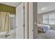 Bathroom and bedroom through an open door with neutral wall colors and decor at 1812 Mountain Lake Nw Dr, Kennesaw, GA 30152