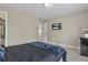 Bedroom with a view to the carpeted hallway and a mini fridge to the side at 1812 Mountain Lake Nw Dr, Kennesaw, GA 30152