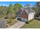 Charming two-story home with a two-car garage, pristine landscaping, and a spacious driveway on a sunny day at 1812 Mountain Lake Nw Dr, Kennesaw, GA 30152