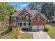 Beautiful two-story brick home with a well-manicured lawn, two-car garage, and welcoming front porch at 1812 Mountain Lake Nw Dr, Kennesaw, GA 30152