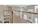 View from the carpeted hallway of the living room with fireplace and backyard views at 1812 Mountain Lake Nw Dr, Kennesaw, GA 30152