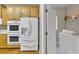 View of kitchen featuring wooden cabinets, stainless steel appliances, a breakfast bar, and access to a laundry room at 1812 Mountain Lake Nw Dr, Kennesaw, GA 30152