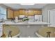 Cozy kitchen featuring wood cabinets, modern appliances, breakfast bar, and tile backsplash, perfect for everyday dining at 1812 Mountain Lake Nw Dr, Kennesaw, GA 30152