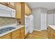 Well-equipped kitchen featuring wooden cabinets, stainless steel appliances, and an adjacent dining area, ideal for cooking at 1812 Mountain Lake Nw Dr, Kennesaw, GA 30152