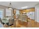 Bright kitchen with wooden cabinets, stainless steel appliances, a breakfast bar, and an adjacent dining area at 1812 Mountain Lake Nw Dr, Kennesaw, GA 30152