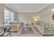 Cozy living room with neutral walls, comfortable seating, and a window at 1812 Mountain Lake Nw Dr, Kennesaw, GA 30152