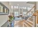 Bright, open-concept living area featuring high ceilings, hardwood floors, a cozy fireplace, and large windows at 1812 Mountain Lake Nw Dr, Kennesaw, GA 30152