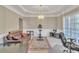 Spacious living room with exercise equipment, leather couch, and natural light at 1812 Mountain Lake Nw Dr, Kennesaw, GA 30152