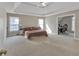 Main bedroom featuring a tray ceiling, carpeted floor, and office space at 1812 Mountain Lake Nw Dr, Kennesaw, GA 30152