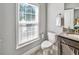 Bright bathroom with window, toilet, and contemporary vanity at 1923 Prospect Park Ln, Decatur, GA 30033