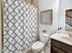 Bathroom featuring a toilet, sink with a dark brown vanity, and a shower with patterned curtains at 1923 Prospect Park Ln, Decatur, GA 30033