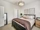Bedroom with carpet, brick accent wall, modern light fixture, and an open closet at 1923 Prospect Park Ln, Decatur, GA 30033