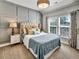 Cozy bedroom featuring tufted headboard, decorative pillows, and stylish curtains at 1923 Prospect Park Ln, Decatur, GA 30033