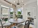 Bright breakfast nook with modern chandelier and sun-drenched windows at 1923 Prospect Park Ln, Decatur, GA 30033
