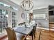 Dining area with modern lighting, wood floors, and backyard views at 1923 Prospect Park Ln, Decatur, GA 30033
