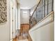 Entryway features hardwood flooring, staircase, and white door with a storm door view to the outside at 1923 Prospect Park Ln, Decatur, GA 30033