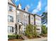 Attractive townhome featuring stone accents, a covered entrance, and a well-maintained front yard at 1923 Prospect Park Ln, Decatur, GA 30033