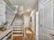 Entryway with hardwood flooring, staircase, and a view into the downstairs bathroom at 1923 Prospect Park Ln, Decatur, GA 30033