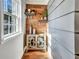 Hallway featuring custom shelving, wood floors and natural light at 1923 Prospect Park Ln, Decatur, GA 30033