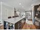 Modern kitchen with large center island, stainless steel appliances, and bar seating overlooking the living space at 1923 Prospect Park Ln, Decatur, GA 30033