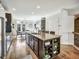 Spacious kitchen island with bar seating, stainless steel appliances, and adjacent dining area at 1923 Prospect Park Ln, Decatur, GA 30033