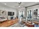 Living room boasts hardwood floors, modern furnishings, fireplace, and abundant natural light at 1923 Prospect Park Ln, Decatur, GA 30033