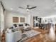 Open living room features hardwood floors, ceiling fan, modern decor, and seamless flow to the kitchen at 1923 Prospect Park Ln, Decatur, GA 30033