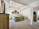 Spacious main bedroom with brick accent wall, tray ceiling, and plush carpet at 1923 Prospect Park Ln, Decatur, GA 30033