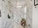 Modern glass shower with white marble-style tiles and shelving at 1923 Prospect Park Ln, Decatur, GA 30033