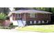 Charming brick home featuring a well-maintained lawn and inviting front entrance at 223 Lucerne St, Decatur, GA 30030