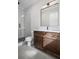 Bathroom with modern vanity, black hardware, and tiled walk-in shower at 584 Indian Hills Pkwy, Marietta, GA 30068