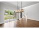 Dining room featuring hardwood floors, modern chandelier, and views to the deck at 584 Indian Hills Pkwy, Marietta, GA 30068