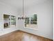 Dining room with modern chandelier and views to the outdoor fireplace on the screened in porch at 584 Indian Hills Pkwy, Marietta, GA 30068
