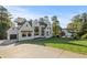 Beautiful white painted home with a three car garage and expansive manicured lawn at 584 Indian Hills Pkwy, Marietta, GA 30068