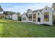 Stunning white two-story home with black trim, large windows, and a lush green lawn at 584 Indian Hills Pkwy, Marietta, GA 30068