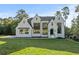 Stunning white painted home with black trim and modern windows on a lush green lawn at 584 Indian Hills Pkwy, Marietta, GA 30068
