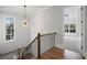 Hallway showcasing a decorative light fixture and wood flooring at 584 Indian Hills Pkwy, Marietta, GA 30068