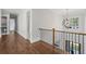 Upper hallway with hardwood flooring and a decorative light fixture at 584 Indian Hills Pkwy, Marietta, GA 30068