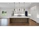 Modern kitchen with a large island, stylish pendant lights, and white cabinetry at 584 Indian Hills Pkwy, Marietta, GA 30068