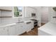 Bright kitchen featuring white cabinets, quartz countertops, stainless steel appliances, and hardwood floors at 584 Indian Hills Pkwy, Marietta, GA 30068