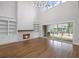 Bright living room featuring fireplace, built-in shelves, and sliding doors to deck at 584 Indian Hills Pkwy, Marietta, GA 30068